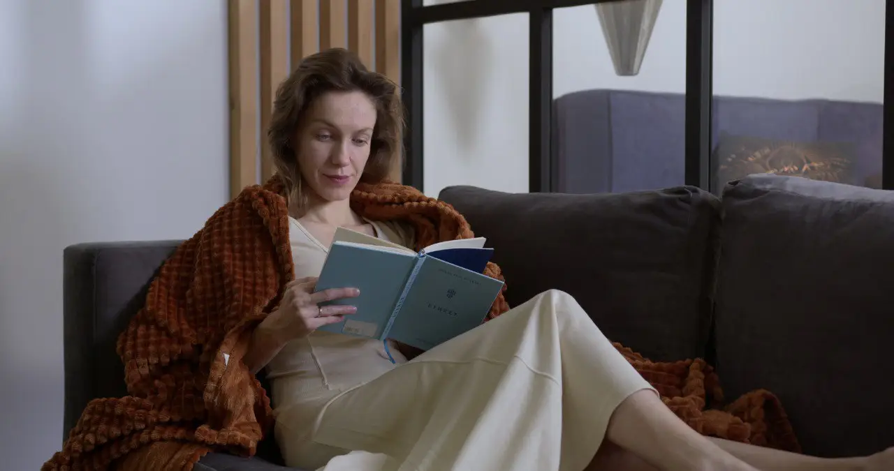 Wide landscape of a sunrise mountain ridge with a solitary walker in silhouette, 3:2 framing to communicate spaciousness and personal growth themes, crisp clarity and natural colors.