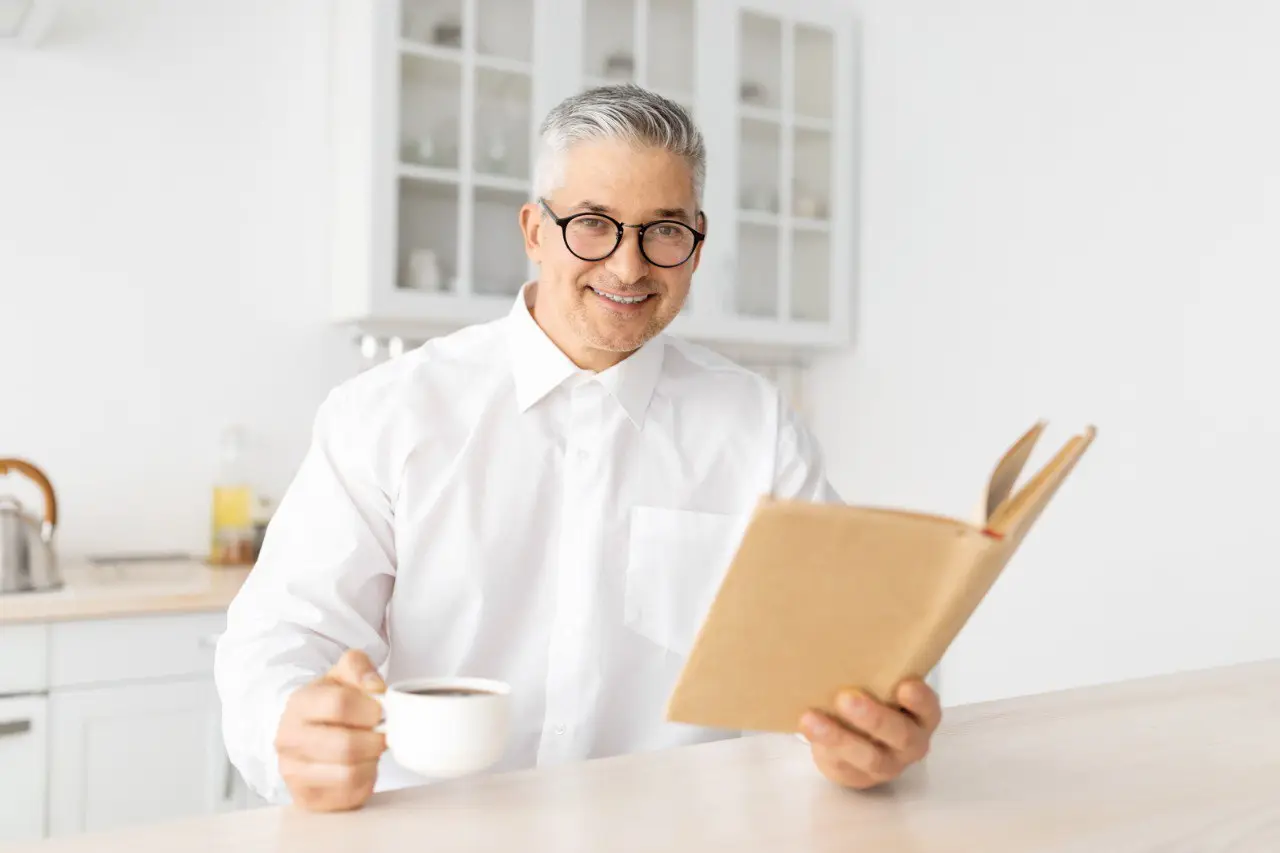 Wide landscape of a sunrise mountain ridge with a solitary walker in silhouette, 3:2 framing to communicate spaciousness and personal growth themes, crisp clarity and natural colors.
