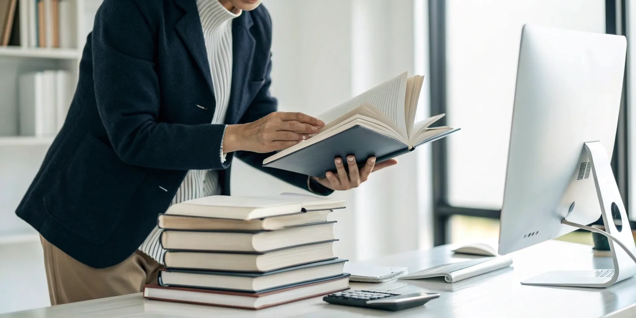 Person at a desk with books, learning from the best speed reading course for memory.