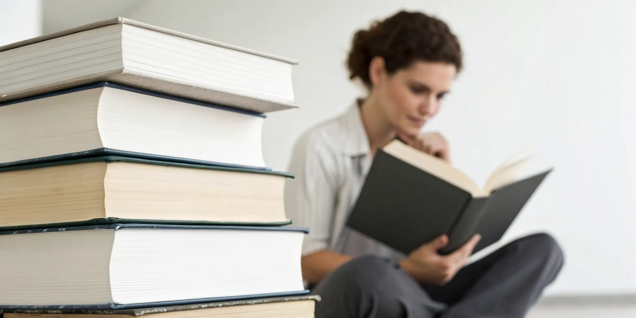 A woman reading a book, learning how to absorb and retain information.